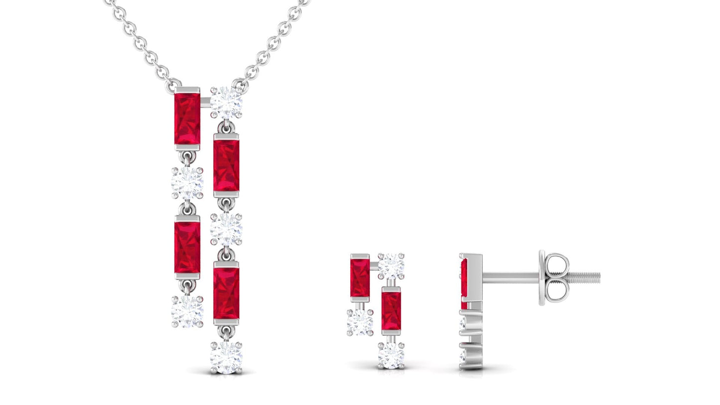 Jewelry set with red gemstones and silver metal on a white background