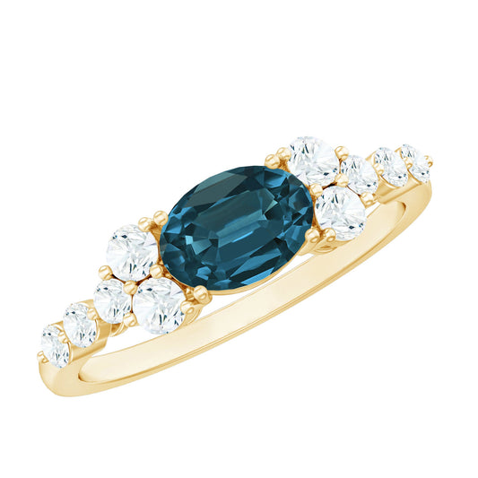 Gold ring with a blue gemstone and clear diamonds on a white background
