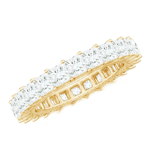Gold ring with clear gemstones on a white background