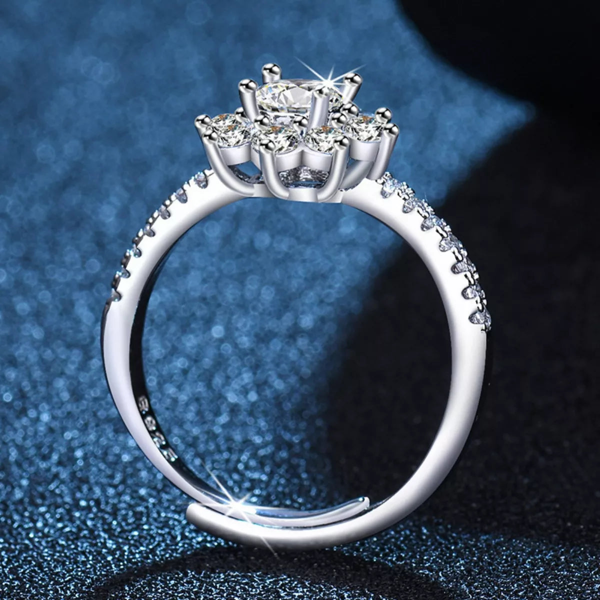 Silver ring with a diamond on a blue and black gradient background