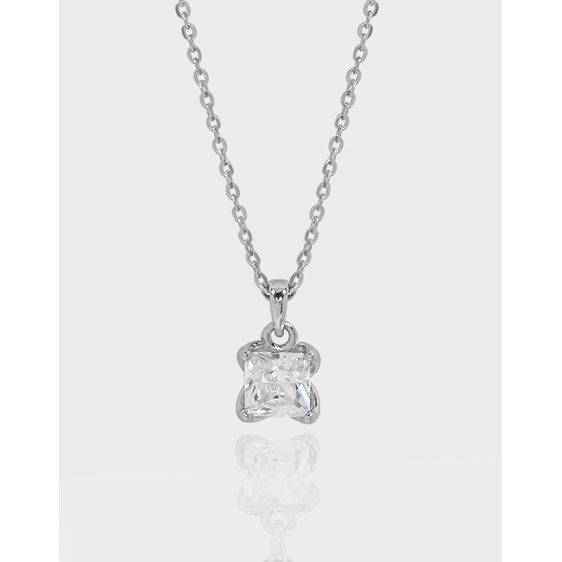 Silver necklace with a diamond pendant on a light gray background