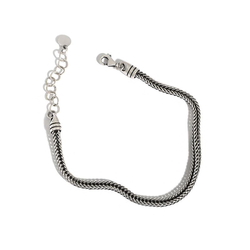 Silver braided bracelet on a white background