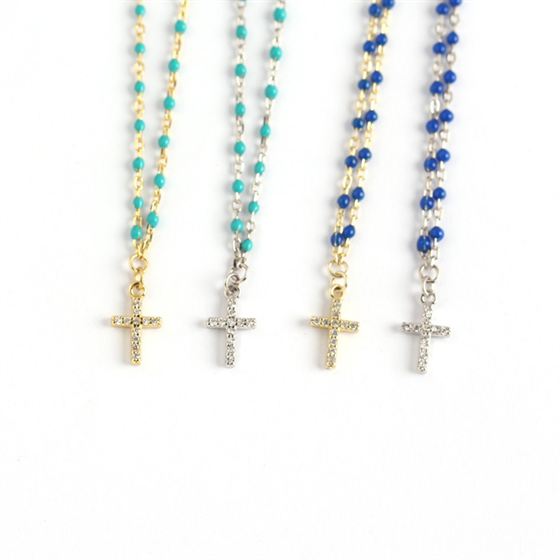 Four beaded necklaces with cross pendants on a white background