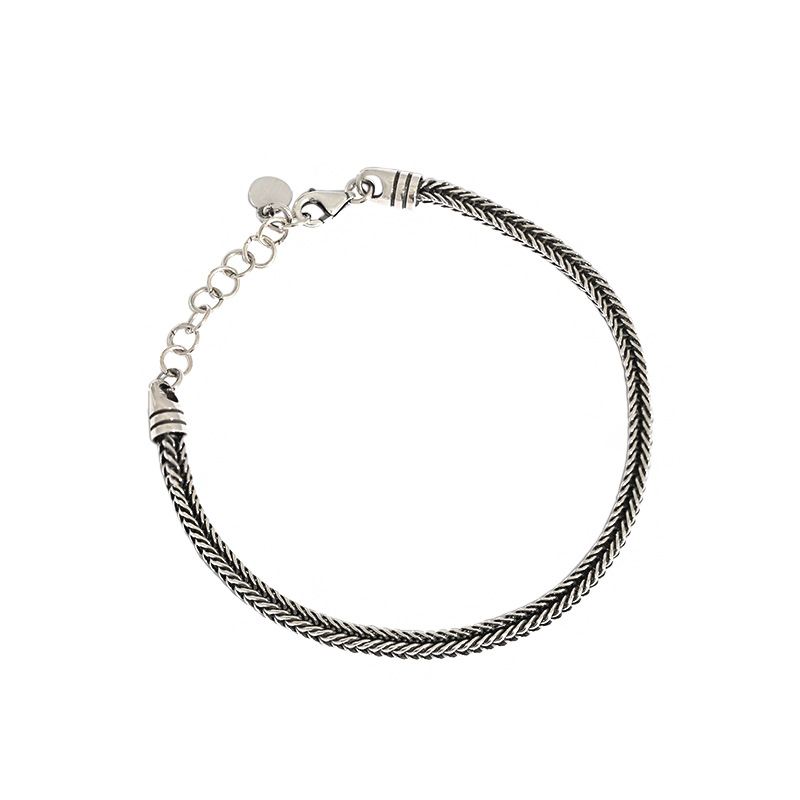 Silver braided bracelet on a white background