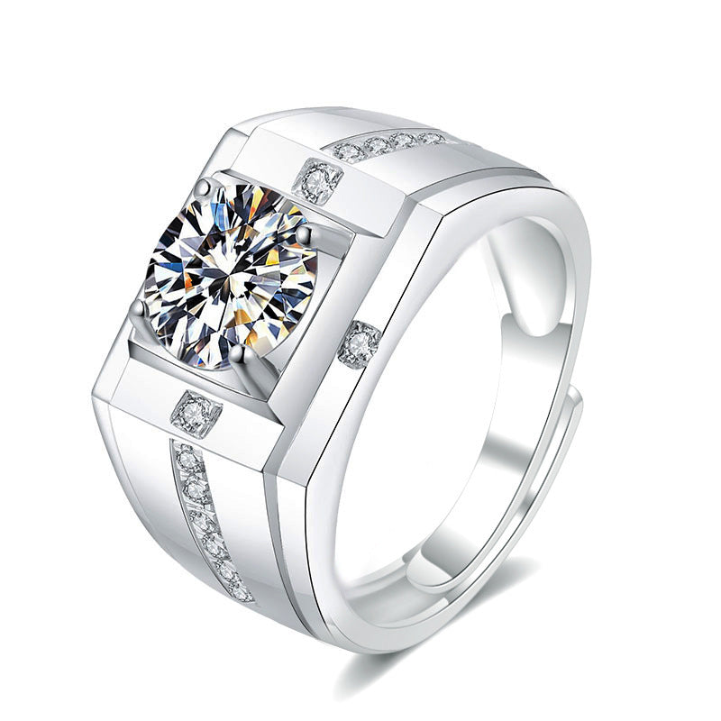 Silver ring with a large diamond and smaller diamonds on the band against a white background