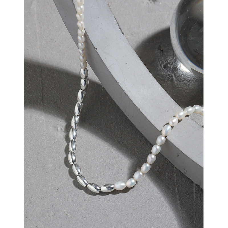 Pearl necklace on a concrete surface with a white base