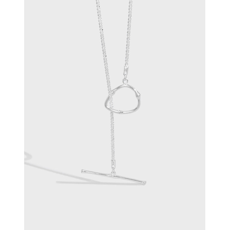Silver necklace with a unique pendant on a light gray background