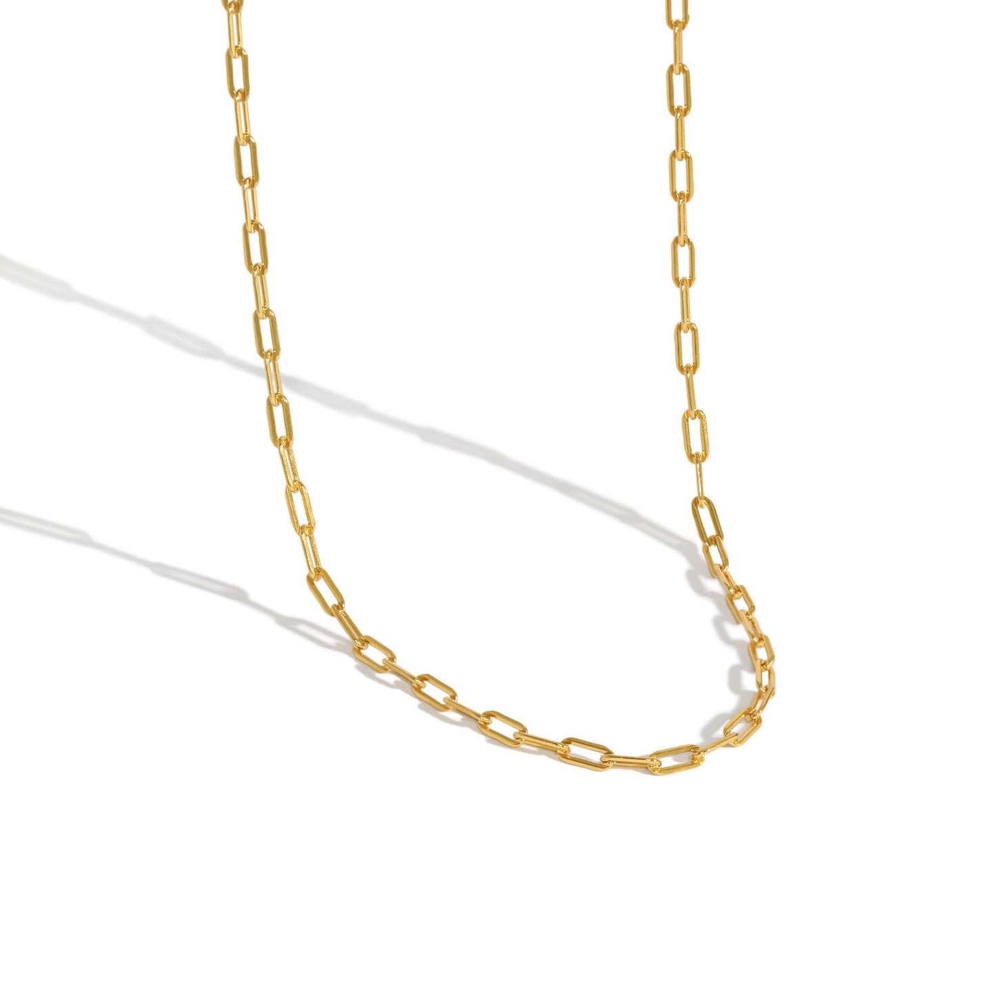 Gold chain necklace on a white background
