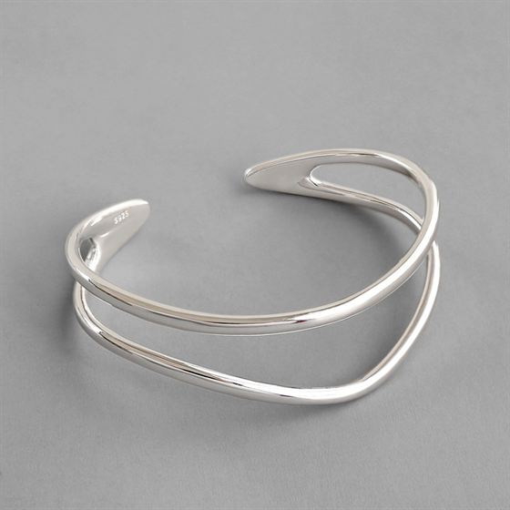 Silver bracelet on a gray background