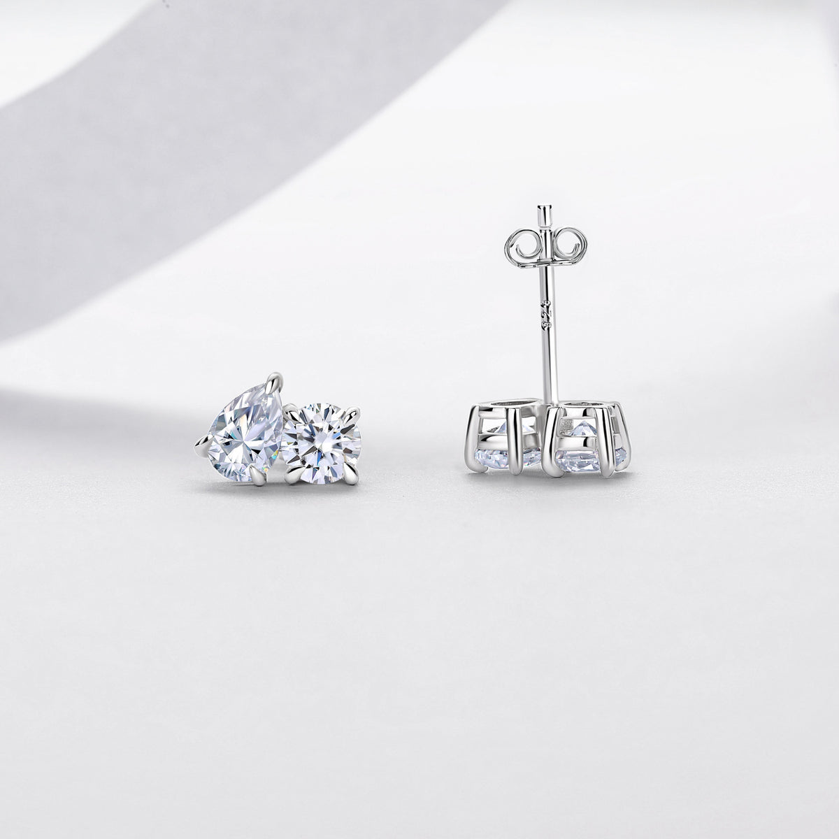 Colorless Moissanite Two Stone  With Round And Pear Shape Stones In 925 Sterling Silver Stud Earrings