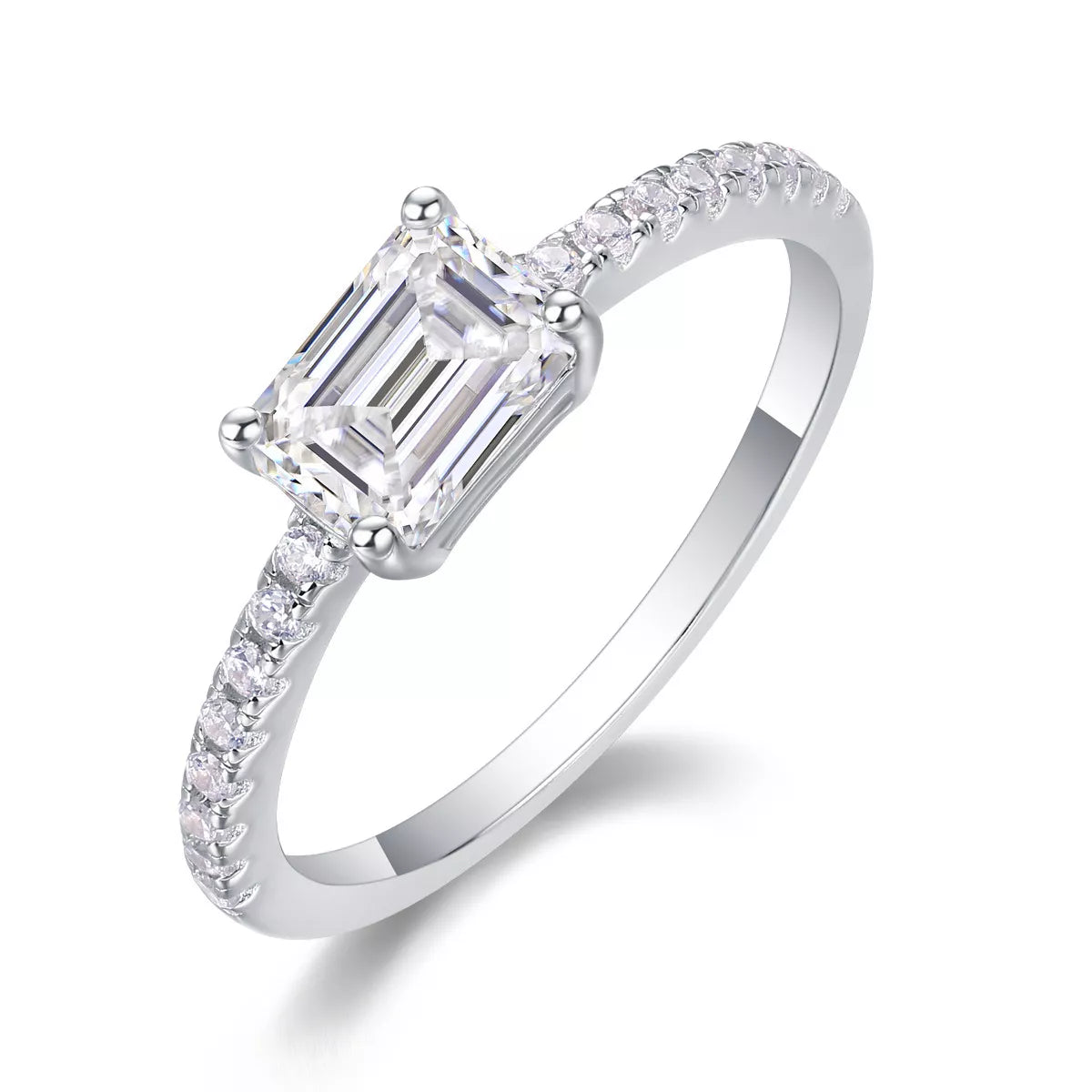 Diamond ring with emerald-cut center stone on a white background
