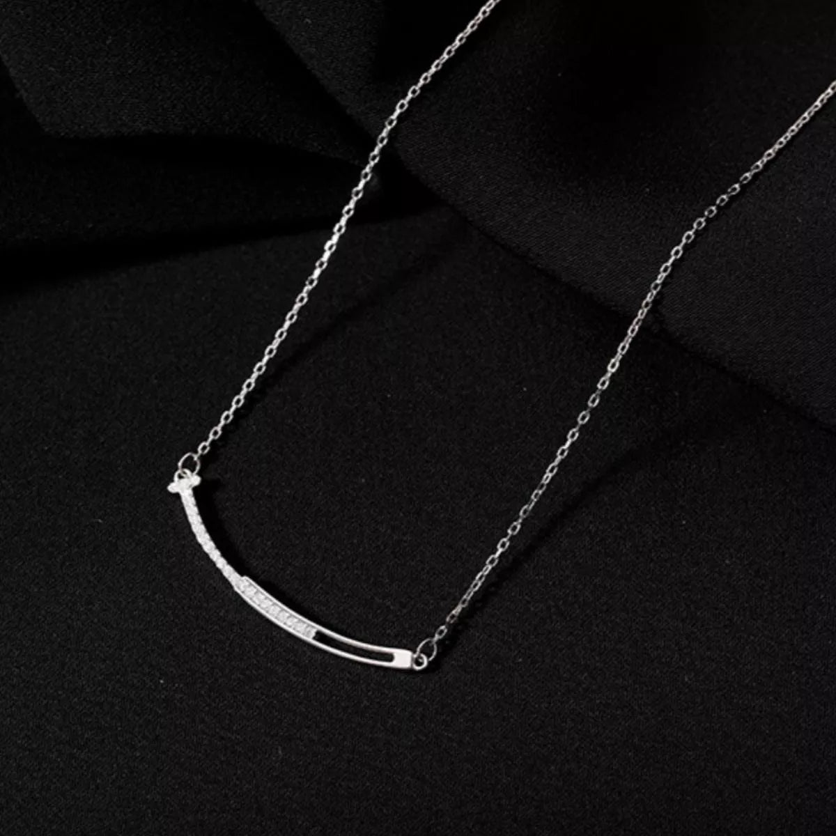 Silver necklace on a black background