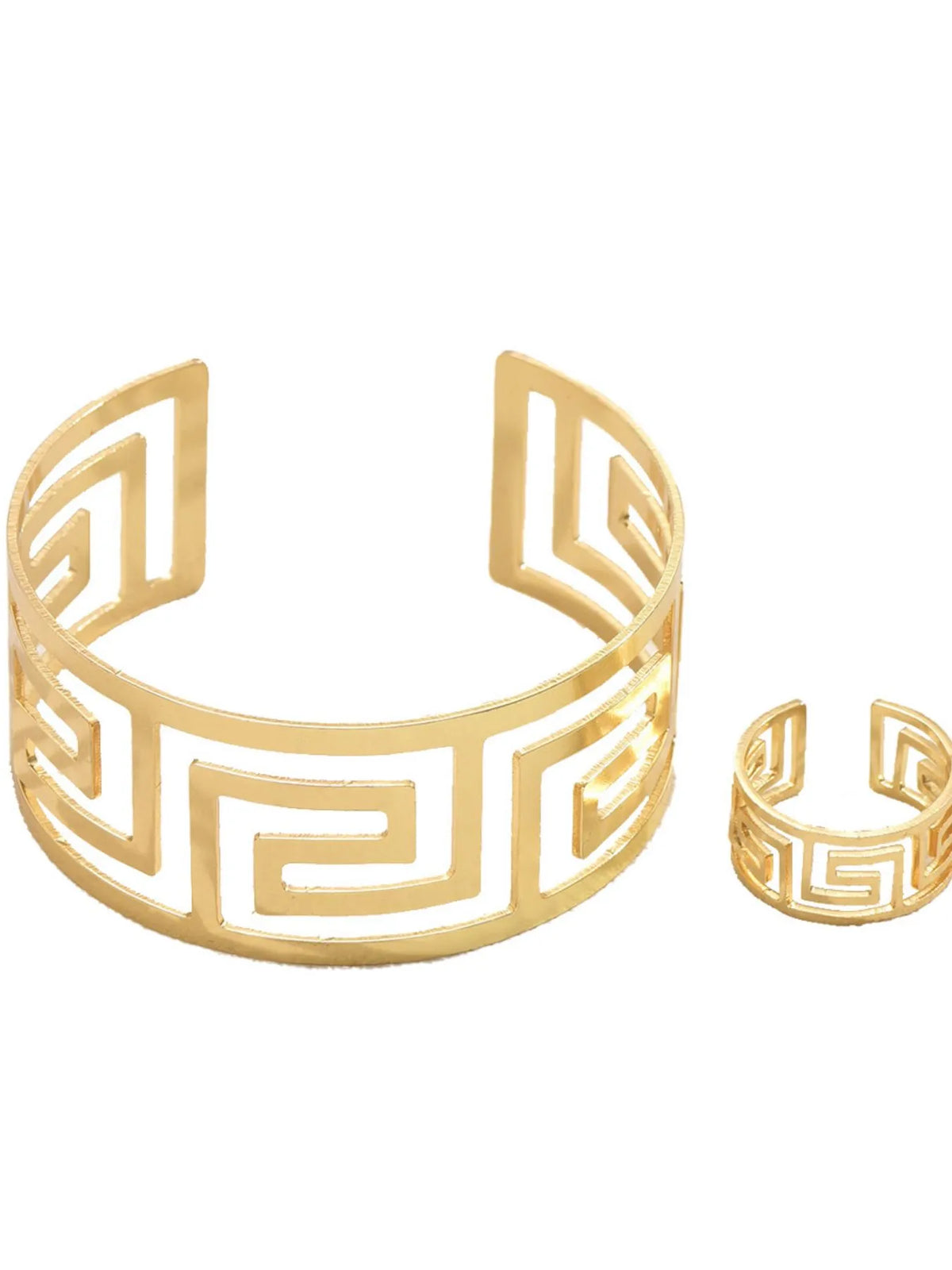 Gold bracelet and ring with Greek key design on a white background