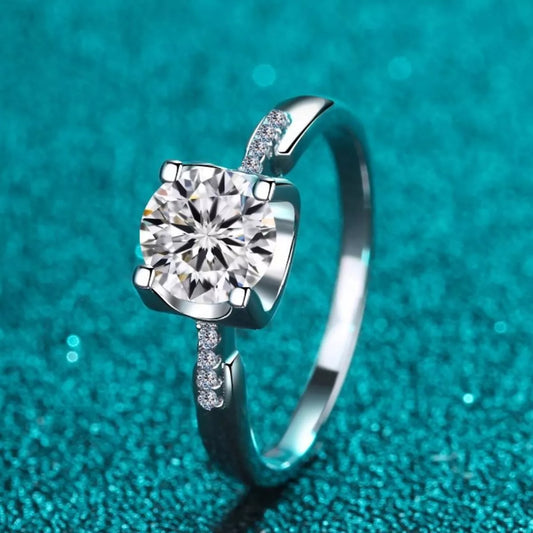 Silver ring with a large diamond on a teal background