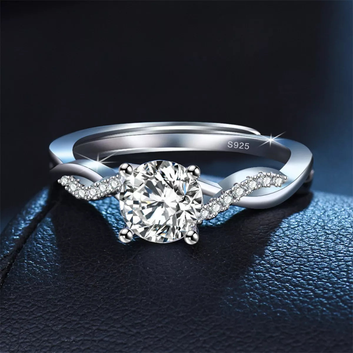 Silver ring with a large diamond on a dark background