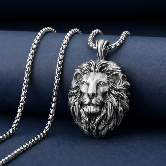 Silver lion pendant necklace on a dark blue background