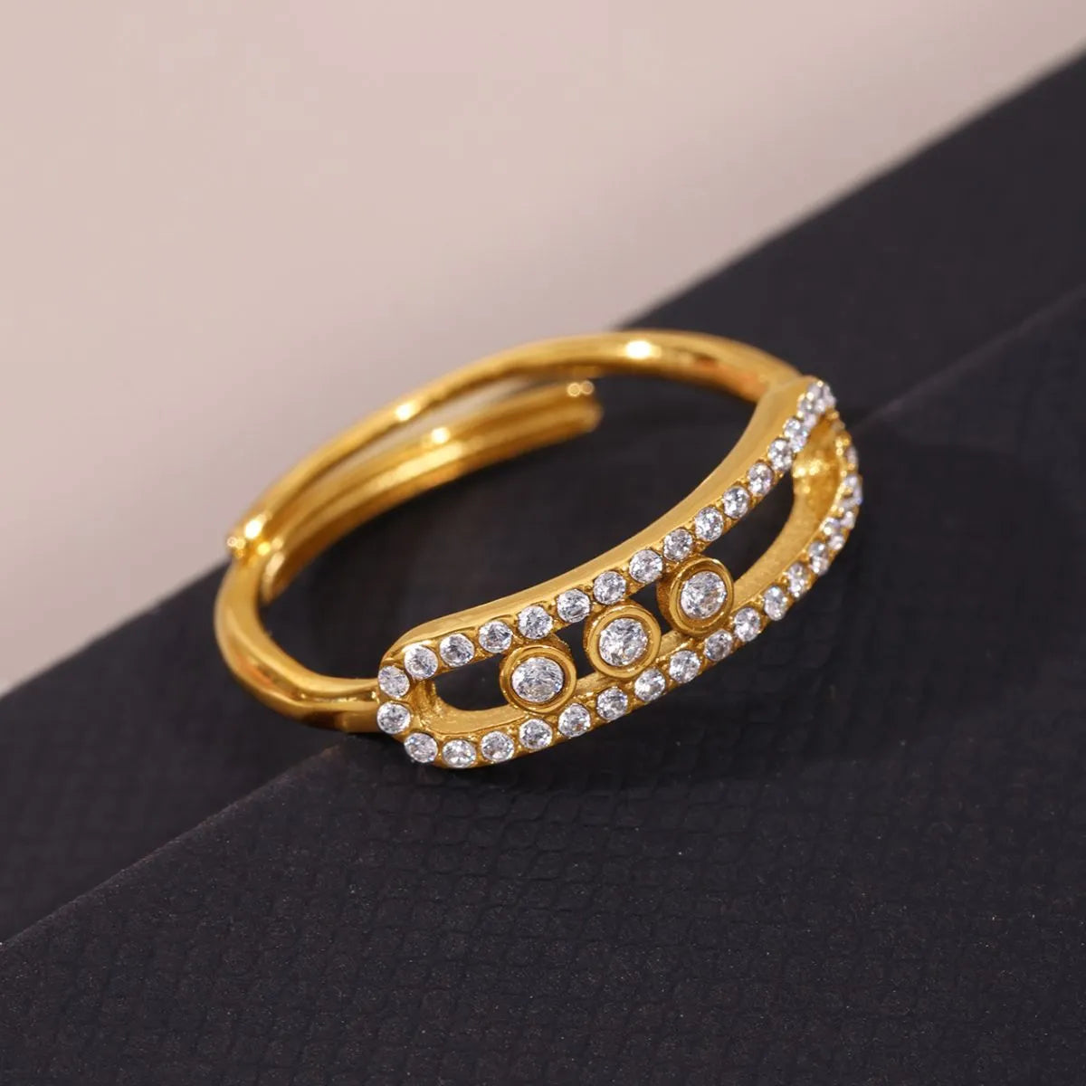 Gold bracelet with diamond accents on a black surface