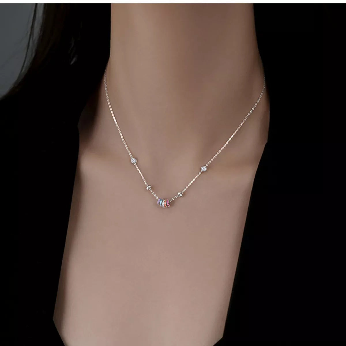 Necklace with colorful beads on a mannequin neck against a black background