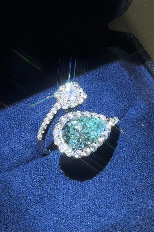 Two rings with gemstones on a blue cushion