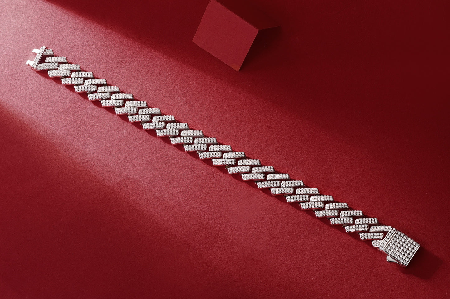 Silver bracelet with diamonds on a red background