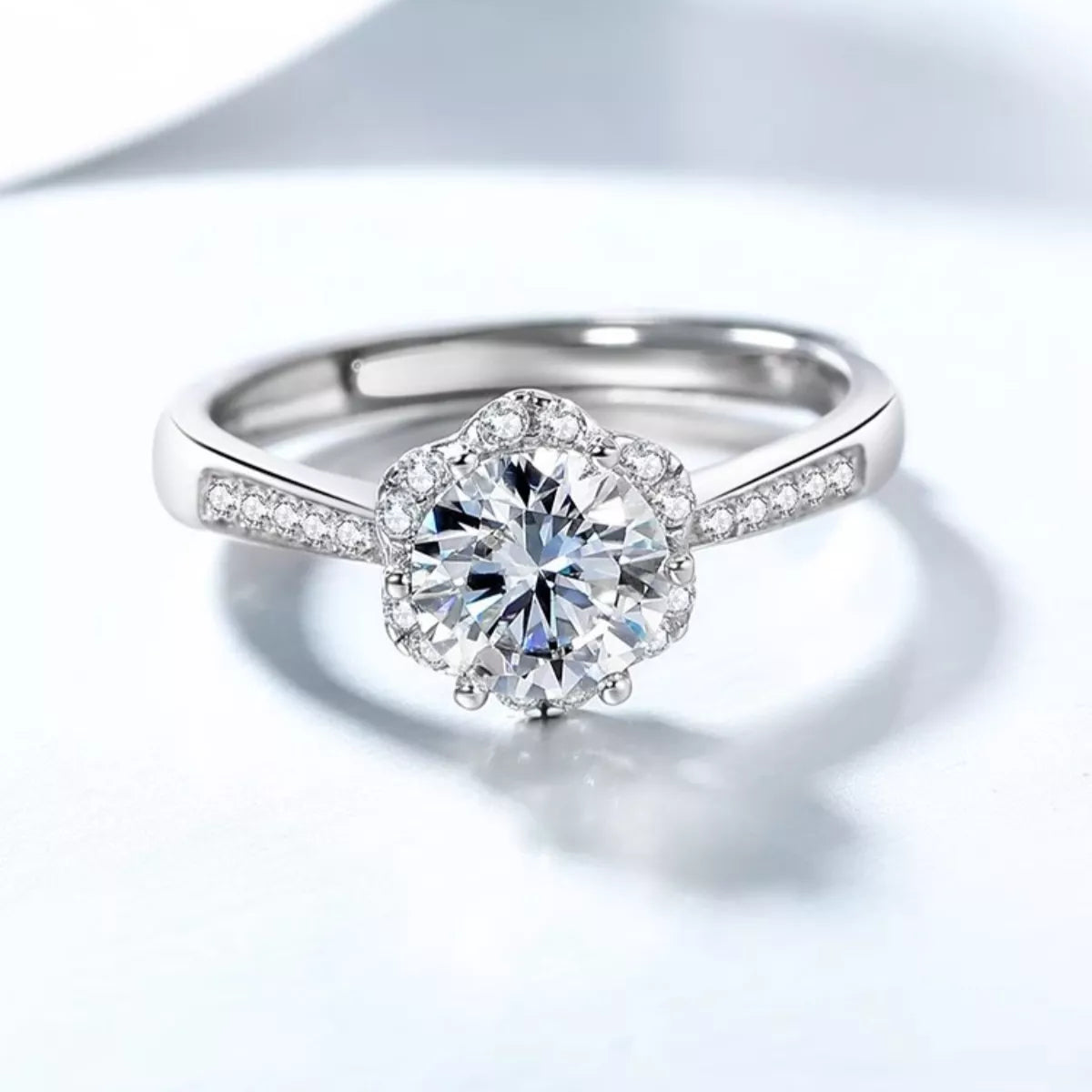 Diamond ring with a clear gemstone on a light gray background