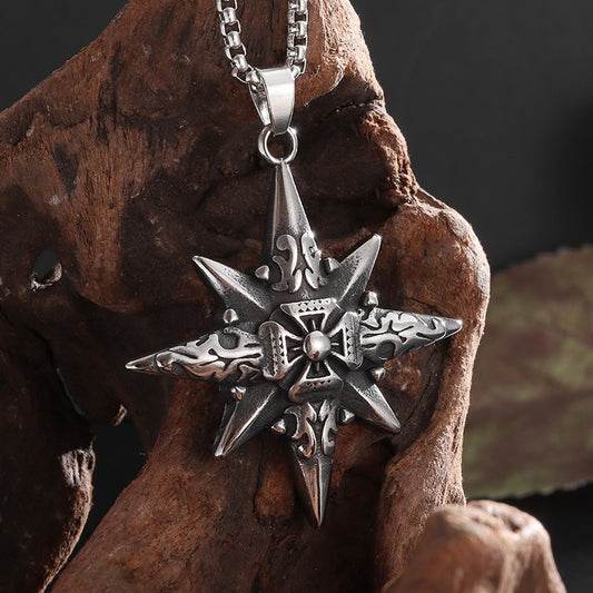 Silver star-shaped pendant on a chain, displayed on a textured brown surface.