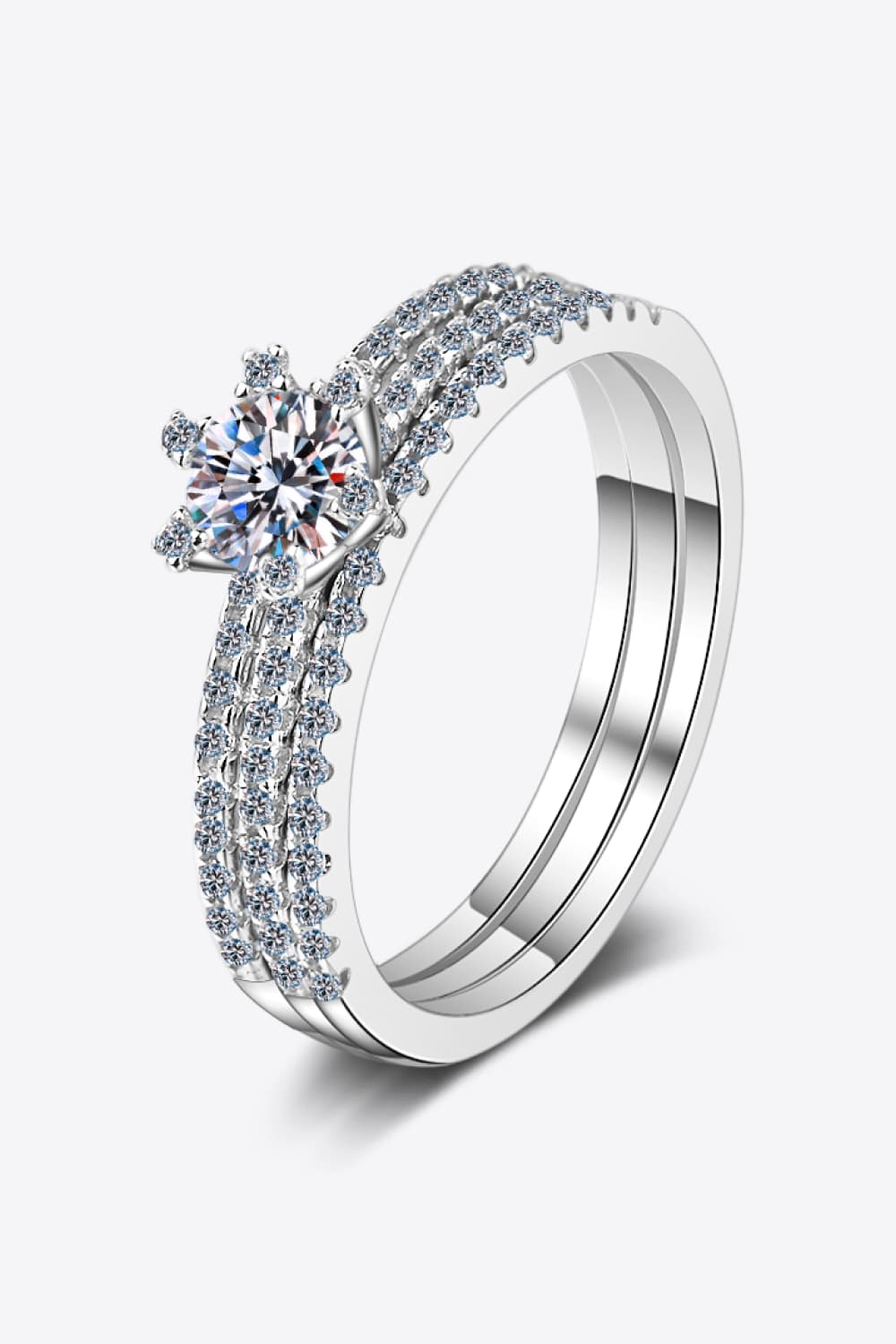 Side-by-side view of a Moissanite 925 sterling silver three-piece ring set including a round solitaire ring and two matching pavé bands | Le'Var Neilson Jewelry