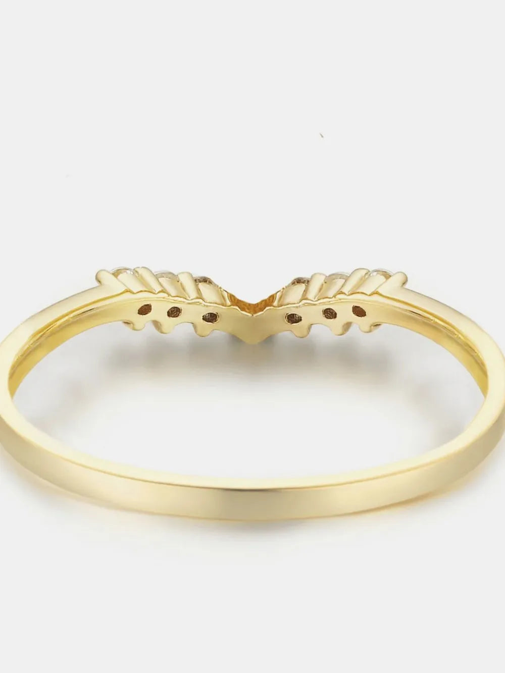 Gold ring with a unique design on a white background