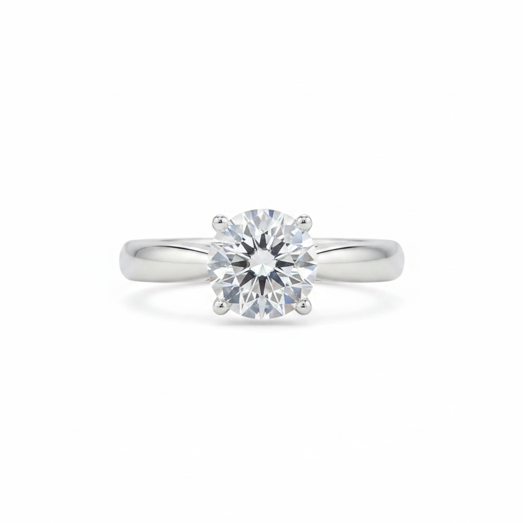 A classic solitaire engagement ring featuring a round brilliant-cut diamond set in a polished white gold or platinum band, centered on a clean white background.